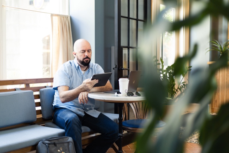 Person reading on a tablet in a cafe